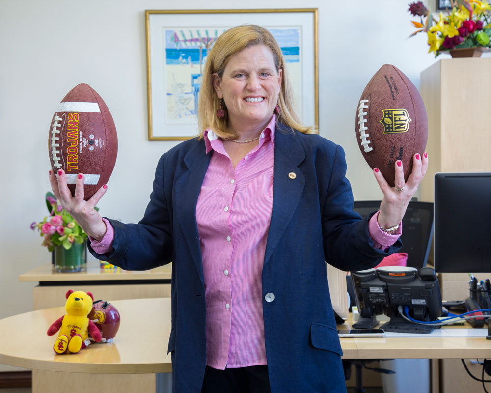 Dr. Endrijonas holds footballs in her opffice.
