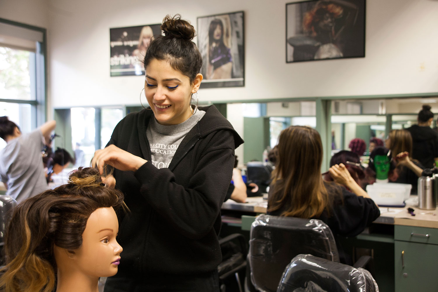 Cosmetology student works during class.