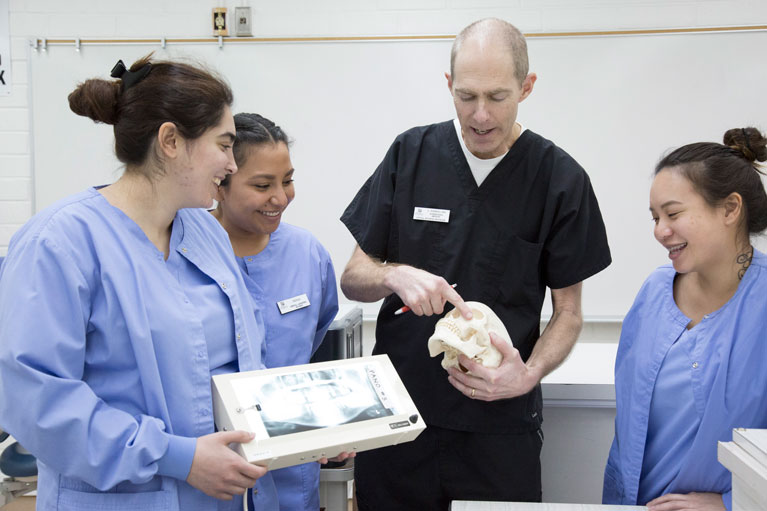 Students get pracitcal training in radiographs during a denal assisting class.