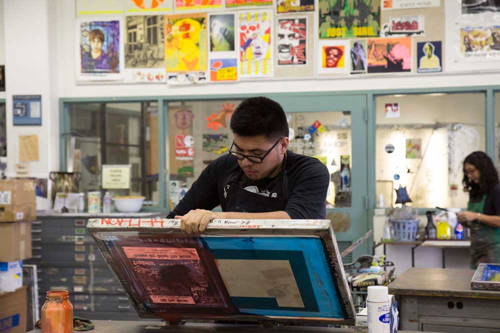 Student works during a screen printing class at PCC.