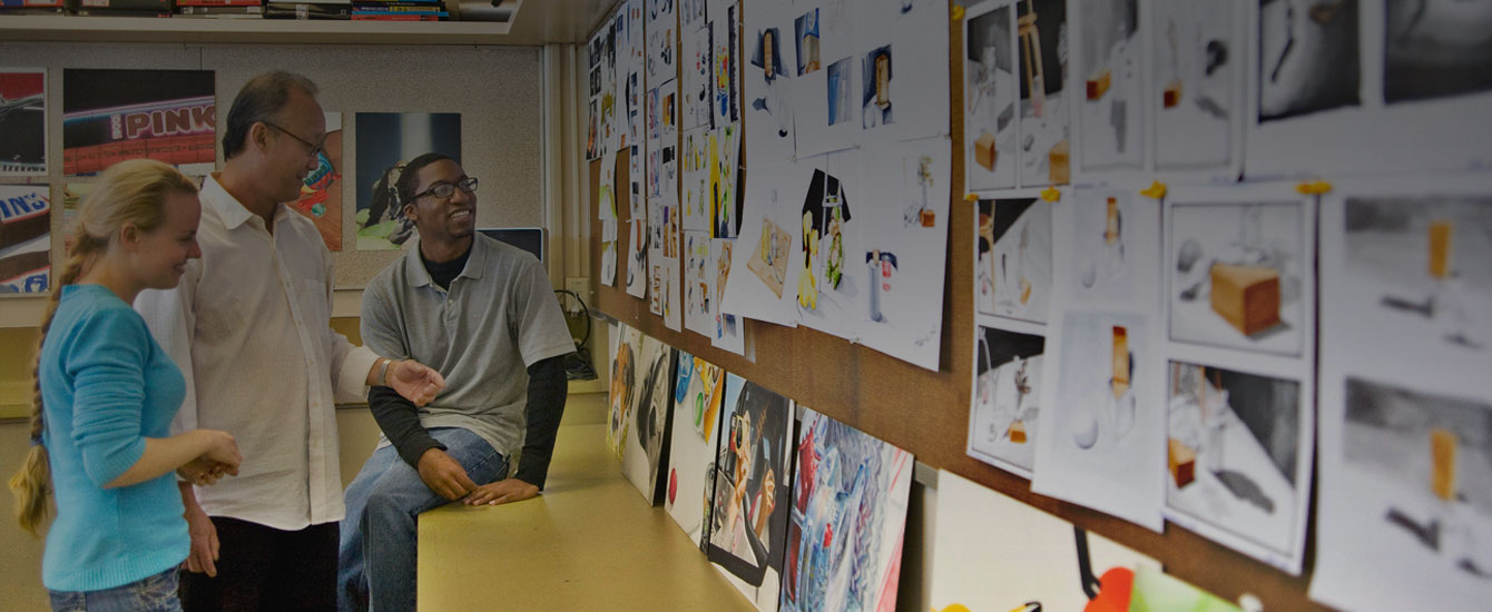 Students and faculty look at work during a digital media class.