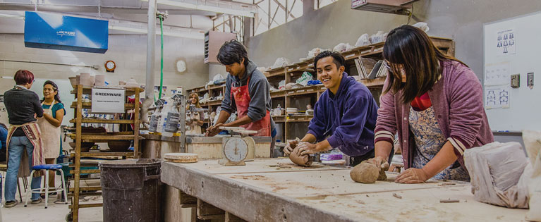 Students work together in a ceramics class.
