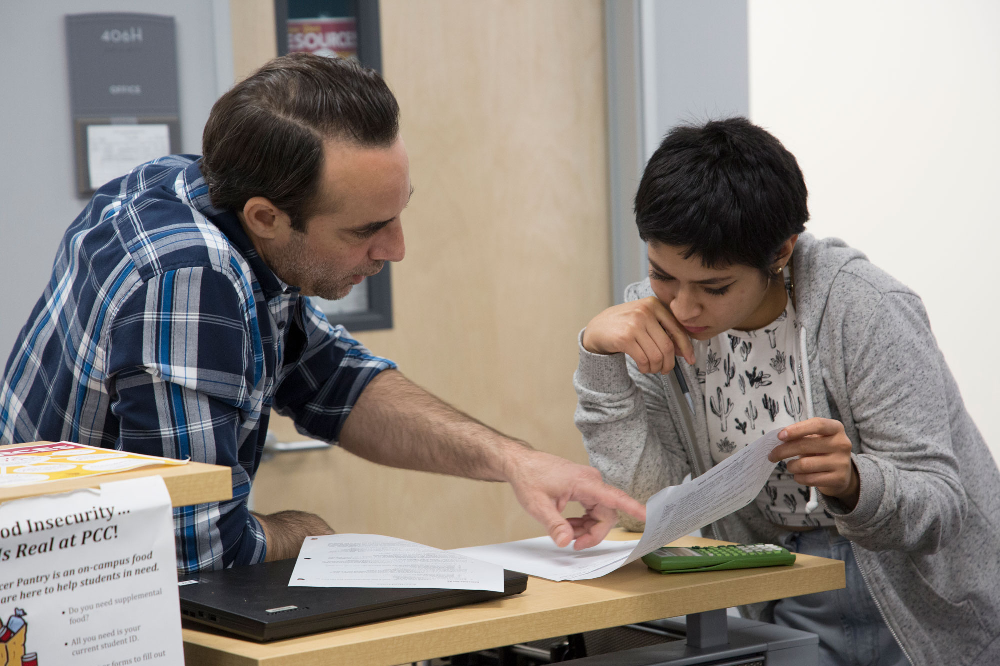 A peer tutor helps a student in the math resource center
